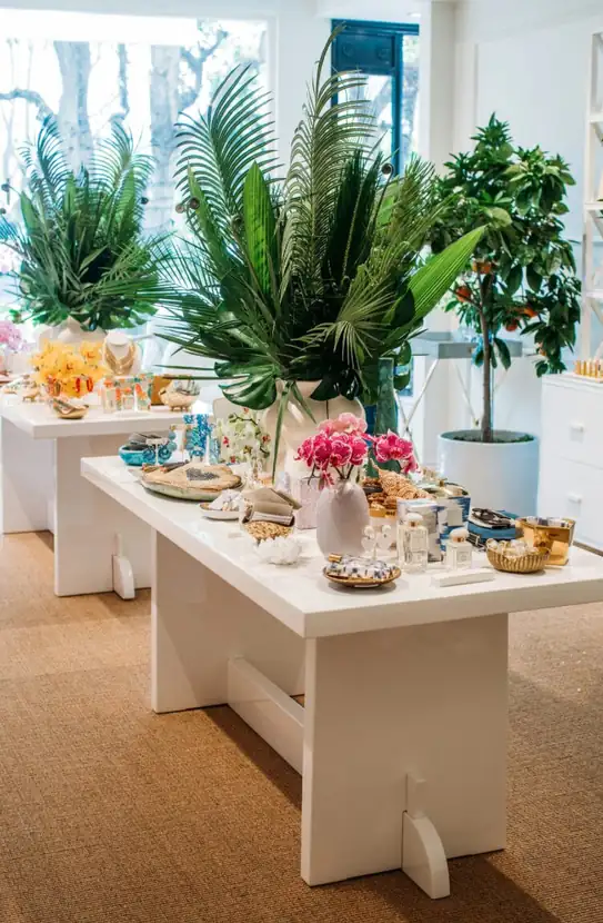 Product table styled with palms, citrus and a fiddle-leaf fig