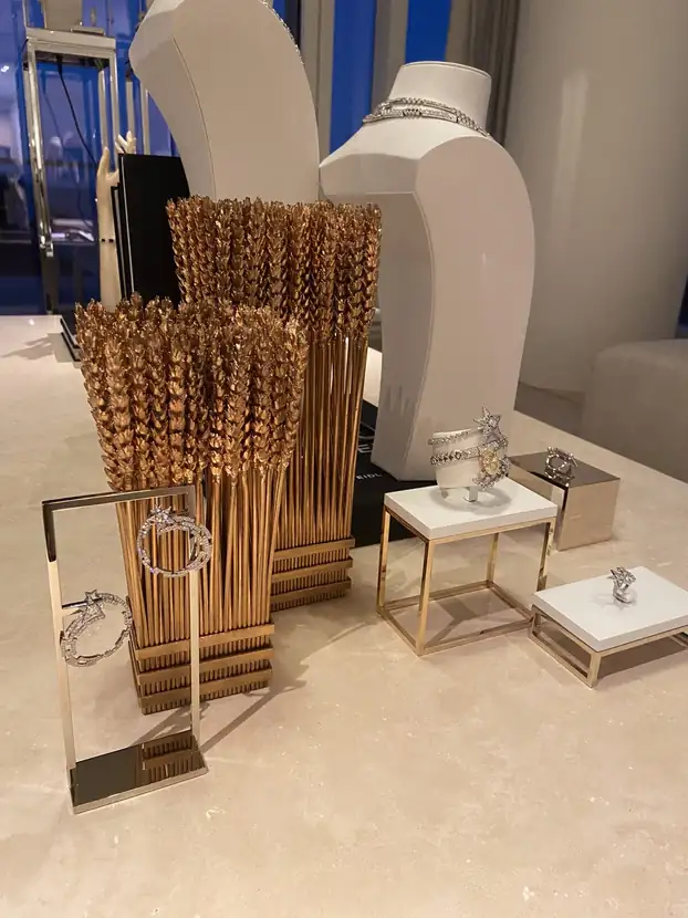 Gold and crystal jewelry display staged on a marble surface