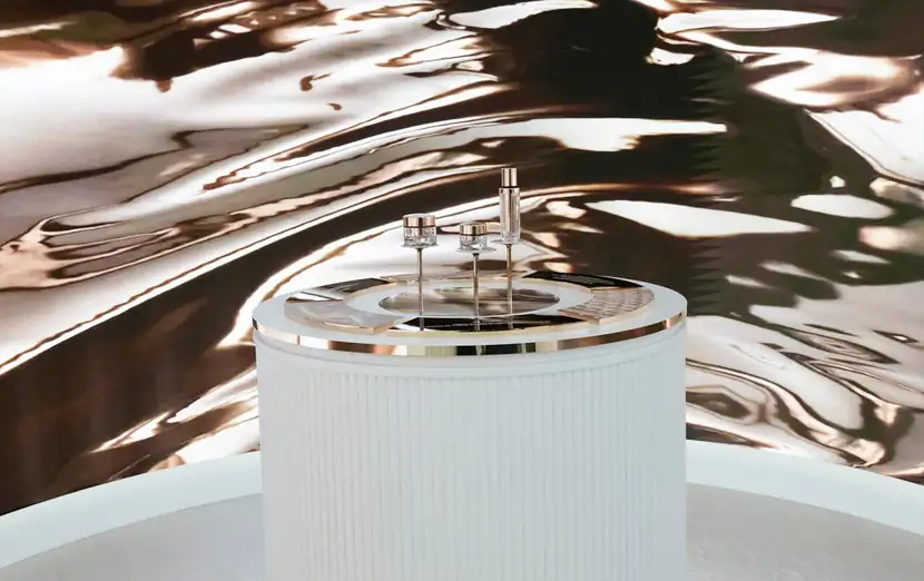 Sculptural product plinth photographed against a liquid chrome backdrop