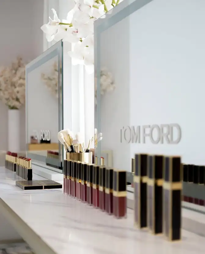 Lip products lined along a mirrored vanity beneath the Tom Ford wordmark