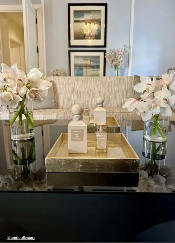White cymbidium orchids styled on a gold tray in the suite