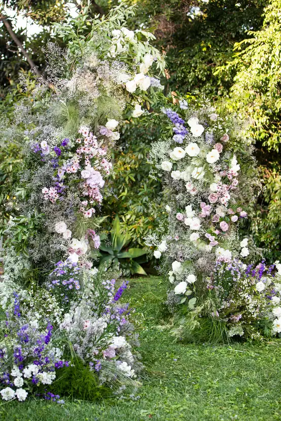 Ceremony arch overflowing with lavender, white and blush blooms
